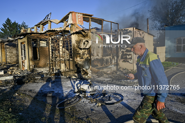 A man is walking past the body of a person killed by the Russian missile attack in central Vilniansk, Zaporizhzhia region, southern Ukraine,...