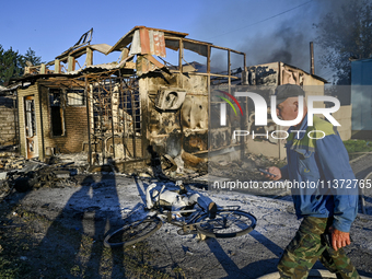 A man is walking past the body of a person killed by the Russian missile attack in central Vilniansk, Zaporizhzhia region, southern Ukraine,...