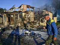 A man is walking past the body of a person killed by the Russian missile attack in central Vilniansk, Zaporizhzhia region, southern Ukraine,...