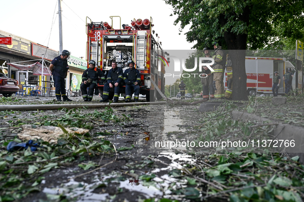 Rescuers are staying by a fire engine during a response effort to the Russian missile attack in central Vilniansk, Zaporizhzhia region, sout...