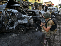 A criminal expert is examining a car destroyed by the Russian missile strike in central Vilniansk, Zaporizhzhia region, southern Ukraine, on...