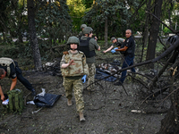 Criminal experts are examining the bodies of people killed by the Russian missile attack in central Vilniansk, Zaporizhzhia region, southern...