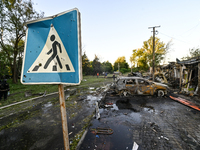 The pedestrian crossing sign is being seen near cars destroyed by the Russian missile attack in central Vilniansk, Zaporizhzhia region, sout...