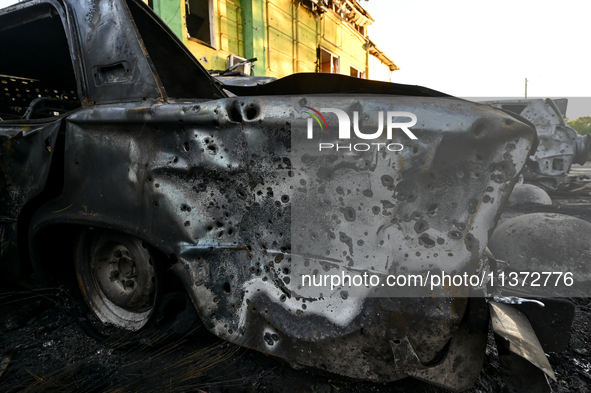 Shrapnel holes are dotting the side of a car wrecked by the Russian missile strike in central Vilniansk, Zaporizhzhia region, southern Ukrai...