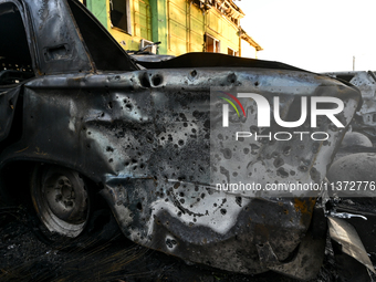 Shrapnel holes are dotting the side of a car wrecked by the Russian missile strike in central Vilniansk, Zaporizhzhia region, southern Ukrai...