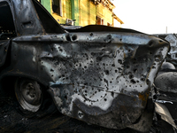 Shrapnel holes are dotting the side of a car wrecked by the Russian missile strike in central Vilniansk, Zaporizhzhia region, southern Ukrai...