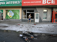 A man is walking past a shop damaged by the Russian missile attack in Vilniansk, Ukraine, on June 29, 2024. Russia is launching rockets at t...