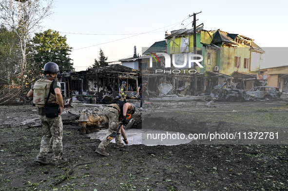 The crater from a Russian missile is being seen in the ground in central Vilniansk, Zaporizhzhia region, southern Ukraine, on June 29, 2024....