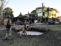 The crater from a Russian missile is being seen in the ground in central Vilniansk, Zaporizhzhia region, southern Ukraine, on June 29, 2024....