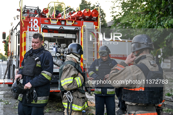 Rescuers are standing by a fire engine during a response effort to the Russian missile attack in central Vilniansk, Zaporizhzhia region, sou...