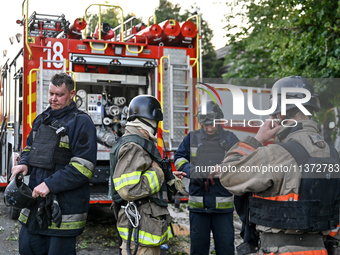 Rescuers are standing by a fire engine during a response effort to the Russian missile attack in central Vilniansk, Zaporizhzhia region, sou...