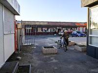 A man is pushing a bicycle at a market near the scene of the Russian missile attack in central Vilniansk, Zaporizhzhia region, southern Ukra...