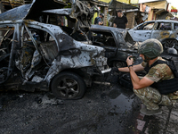 A criminal expert is examining a car destroyed by the Russian missile strike in central Vilniansk, Zaporizhzhia region, southern Ukraine, on...