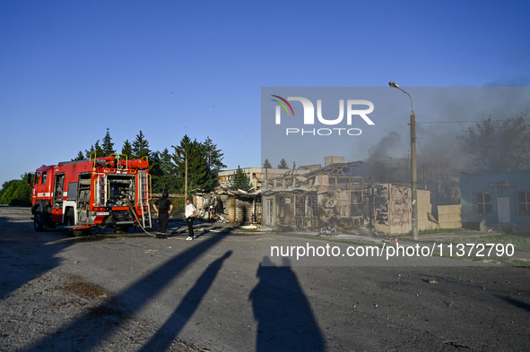 Firefighters are putting out a fire in a building during a response effort to the Russian missile attack in central Vilniansk, Zaporizhzhia...