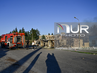 Firefighters are putting out a fire in a building during a response effort to the Russian missile attack in central Vilniansk, Zaporizhzhia...