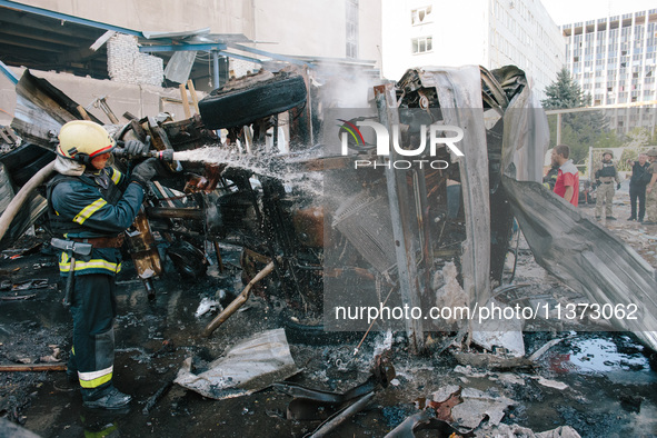 Firefighters are putting out delivery trucks, in Kharkiv, Ukraine, on June 30, 2024. On the afternoon of June 30, 2024, Russia bombed Kharki...