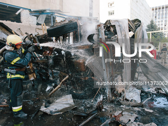 Firefighters are putting out delivery trucks, in Kharkiv, Ukraine, on June 30, 2024. On the afternoon of June 30, 2024, Russia bombed Kharki...