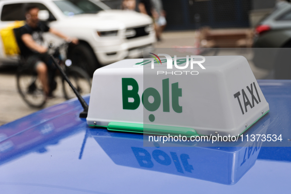 Bolt taxi sign is seen on a car in Krakow, Poland on June 30, 2024. 