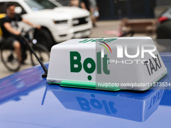 Bolt taxi sign is seen on a car in Krakow, Poland on June 30, 2024. (