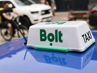 Bolt taxi sign is seen on a car in Krakow, Poland on June 30, 2024. (