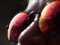 A woman poses as drops from water curtain are seen on her sunglasses during the heatwave in Krakow, Poland on June 30, 2024. (