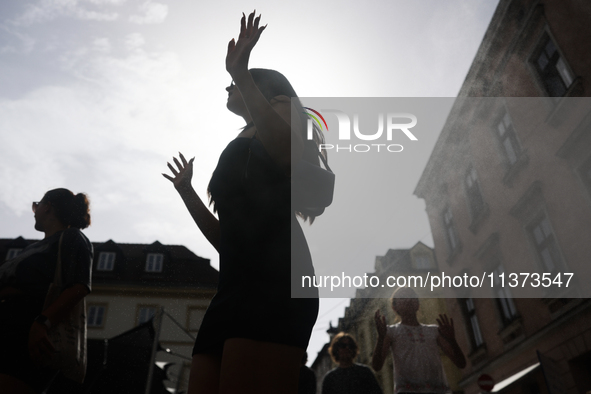 A person cools down at water curtain during the heatwave in Krakow, Poland on June 30, 2024. 