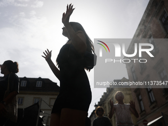 A person cools down at water curtain during the heatwave in Krakow, Poland on June 30, 2024. (