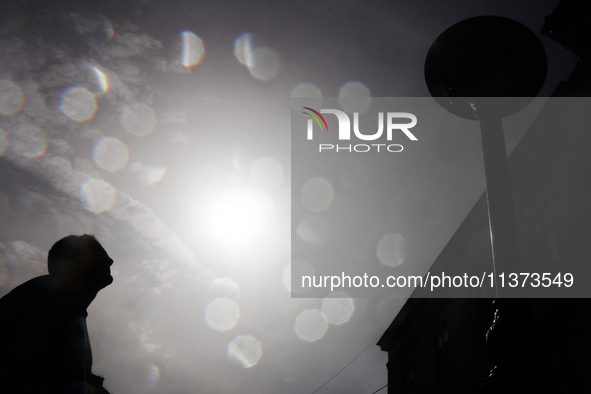 A person cools down at water curtain during the heatwave in Krakow, Poland on June 30, 2024. 