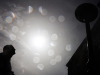 A person cools down at water curtain during the heatwave in Krakow, Poland on June 30, 2024. (