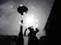 A person cools down at water curtain during the heatwave in Krakow, Poland on June 30, 2024. (