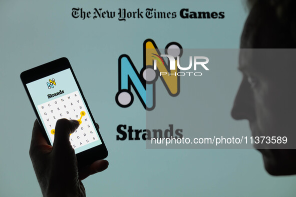 The Strands game is being displayed on a smartphone with NYT Games visible in the background in this photo illustration in Brussels, Belgium...