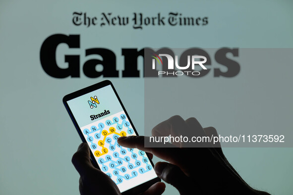 The Strands game is being displayed on a smartphone with NYT Games visible in the background in this photo illustration in Brussels, Belgium...