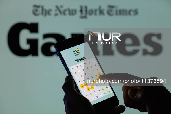 The Strands game is being displayed on a smartphone with NYT Games visible in the background in this photo illustration in Brussels, Belgium...