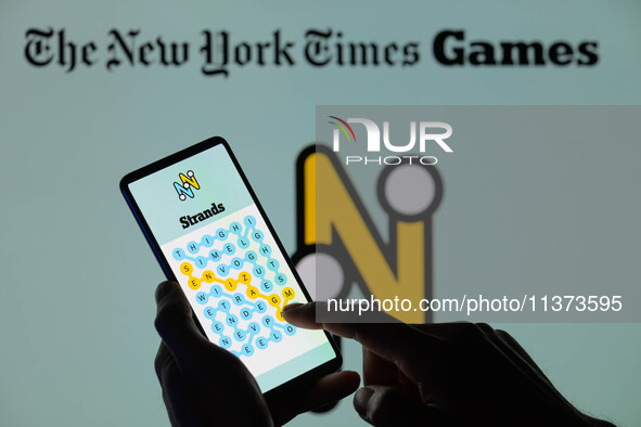 The Strands game is being displayed on a smartphone with NYT Games visible in the background in this photo illustration in Brussels, Belgium...