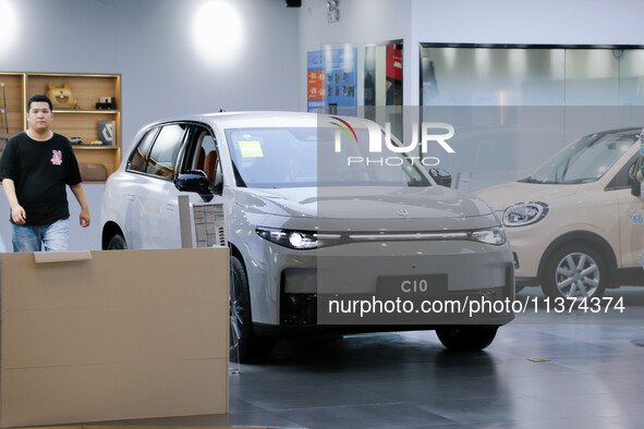 A new energy vehicle is being displayed at a Leapmotor New energy vehicle store in Tianjin, China, on June 30, 2024. 