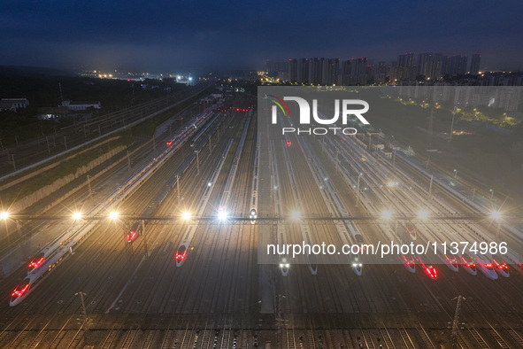 Bullet trains are stopping at the Nanjing section in Nanjing, Jiangsu province, China, in the early morning of July 1, 2024. 