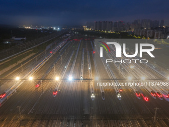 Bullet trains are stopping at the Nanjing section in Nanjing, Jiangsu province, China, in the early morning of July 1, 2024. (