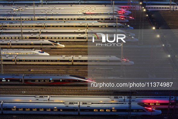 Bullet trains are stopping at the Nanjing section in Nanjing, Jiangsu province, China, in the early morning of July 1, 2024. 