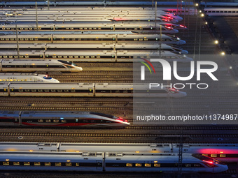 Bullet trains are stopping at the Nanjing section in Nanjing, Jiangsu province, China, in the early morning of July 1, 2024. (