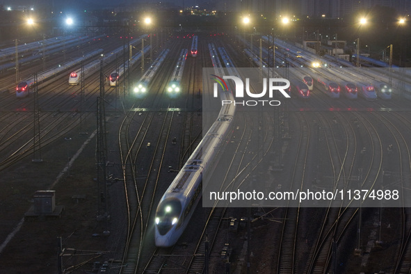 A bullet train is pulling out of the Nanjing Bullet train section in Nanjing, Jiangsu province, China, on July 1, 2024. 