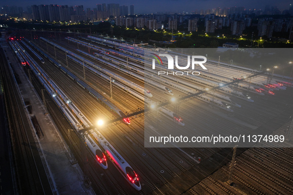 Bullet trains are stopping at the Nanjing section in Nanjing, Jiangsu province, China, in the early morning of July 1, 2024. 