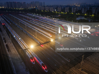 Bullet trains are stopping at the Nanjing section in Nanjing, Jiangsu province, China, in the early morning of July 1, 2024. (