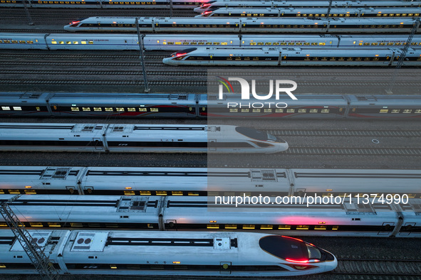 Bullet trains are stopping at the Nanjing section in Nanjing, Jiangsu province, China, in the early morning of July 1, 2024. 