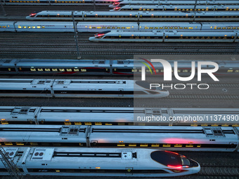 Bullet trains are stopping at the Nanjing section in Nanjing, Jiangsu province, China, in the early morning of July 1, 2024. (