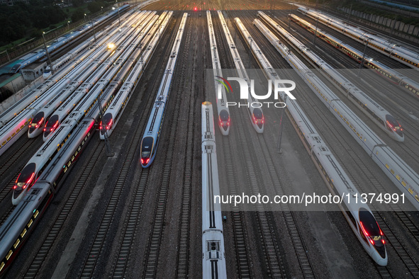 Bullet trains are stopping at the Nanjing section in Nanjing, Jiangsu province, China, in the early morning of July 1, 2024. 