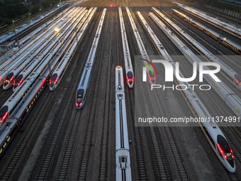 Bullet trains are stopping at the Nanjing section in Nanjing, Jiangsu province, China, in the early morning of July 1, 2024. (