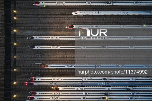 Bullet trains are stopping at the Nanjing section in Nanjing, Jiangsu province, China, in the early morning of July 1, 2024. 