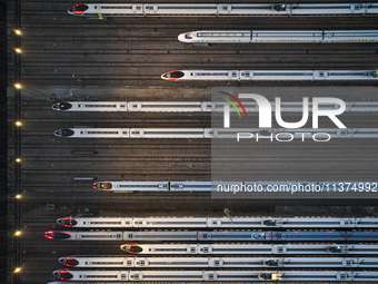 Bullet trains are stopping at the Nanjing section in Nanjing, Jiangsu province, China, in the early morning of July 1, 2024. (