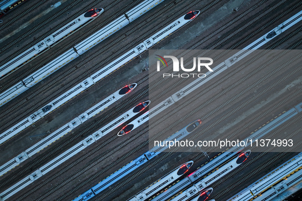 Bullet trains are stopping at the Nanjing section in Nanjing, Jiangsu province, China, in the early morning of July 1, 2024. 