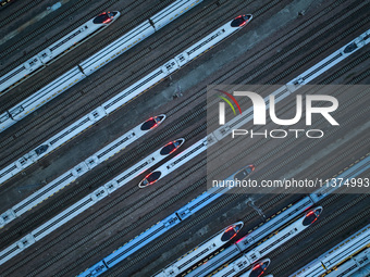 Bullet trains are stopping at the Nanjing section in Nanjing, Jiangsu province, China, in the early morning of July 1, 2024. (